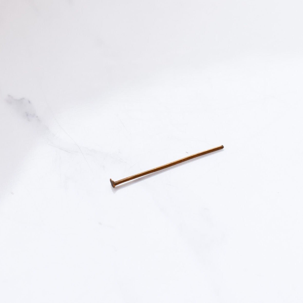 Eye Pin are a jewellery design staple. Once the eye pin is strung through the bead or pendant, its eye can be used to link it to other components of the jewellery and the excess wire peaking out. Caused by the property of material, pins may be bent but that won't impair their use.