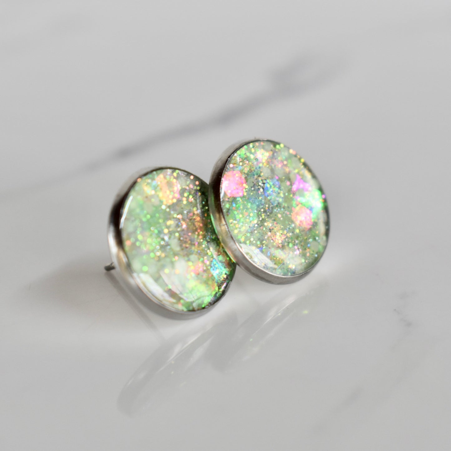 Handmade, light weight and comfortable to wear all day long resin earrings. Available in silver. All our earring hooks are made with a high quality stainless steel and they are hypo allergenic. They will not tarnish or irritate your sensitive skin.
