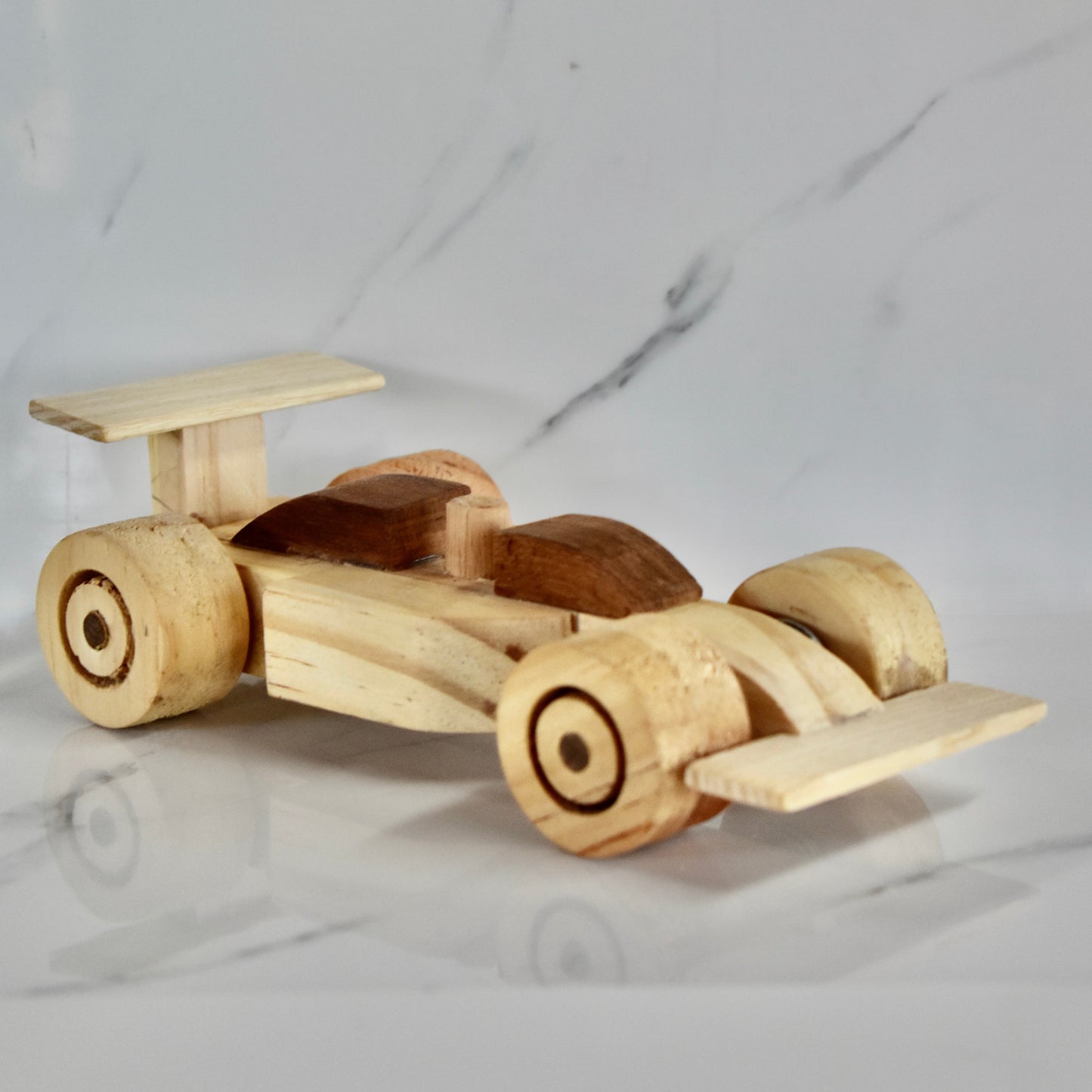This small handmade wooden F1 racing car is the perfect present for any kid (or kid at heart)! It can be left as is or painted for an extra touch of fun. Makes for an amazing baby shower gift. Made with Kiaat solid wood and pine.