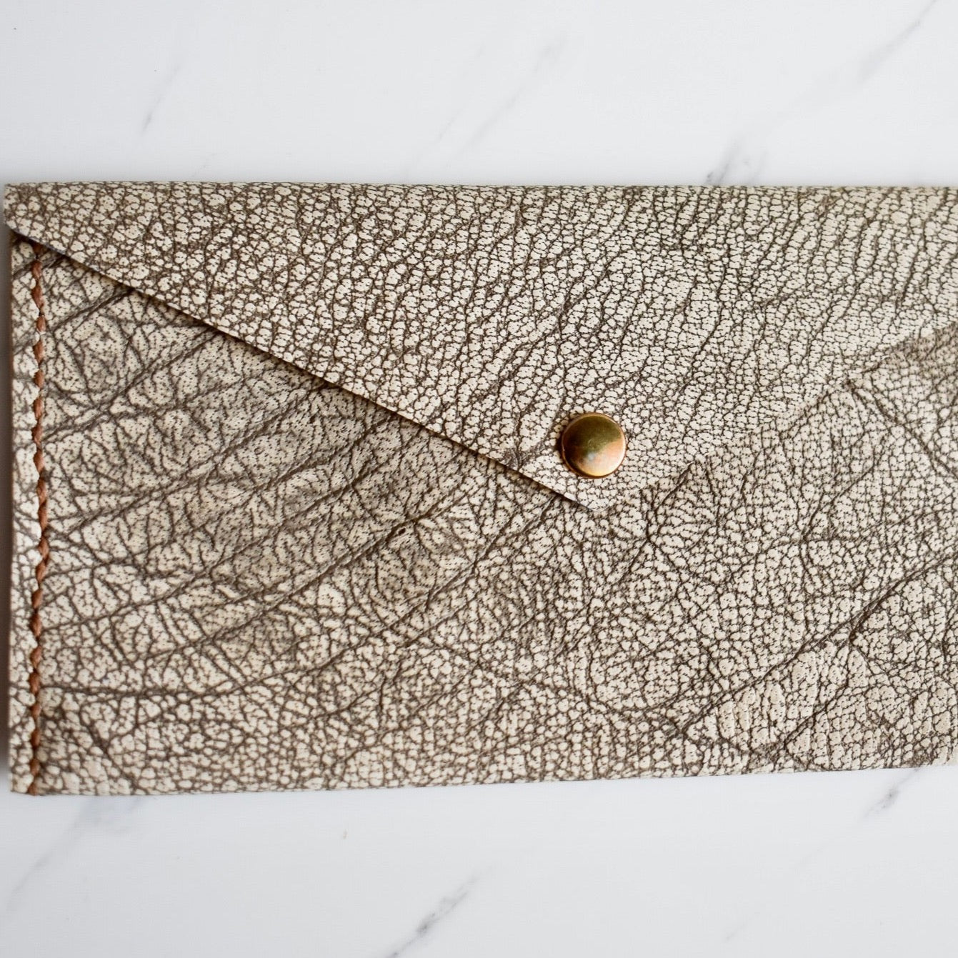 Beautifully handmade and hand stitched leather clutch. Perfect for a quick trip to the shop or even to keep your sunglasses save. Use it as a make up bag or pencil case. This also makes an amazing addition to a bridesmaids gift box.