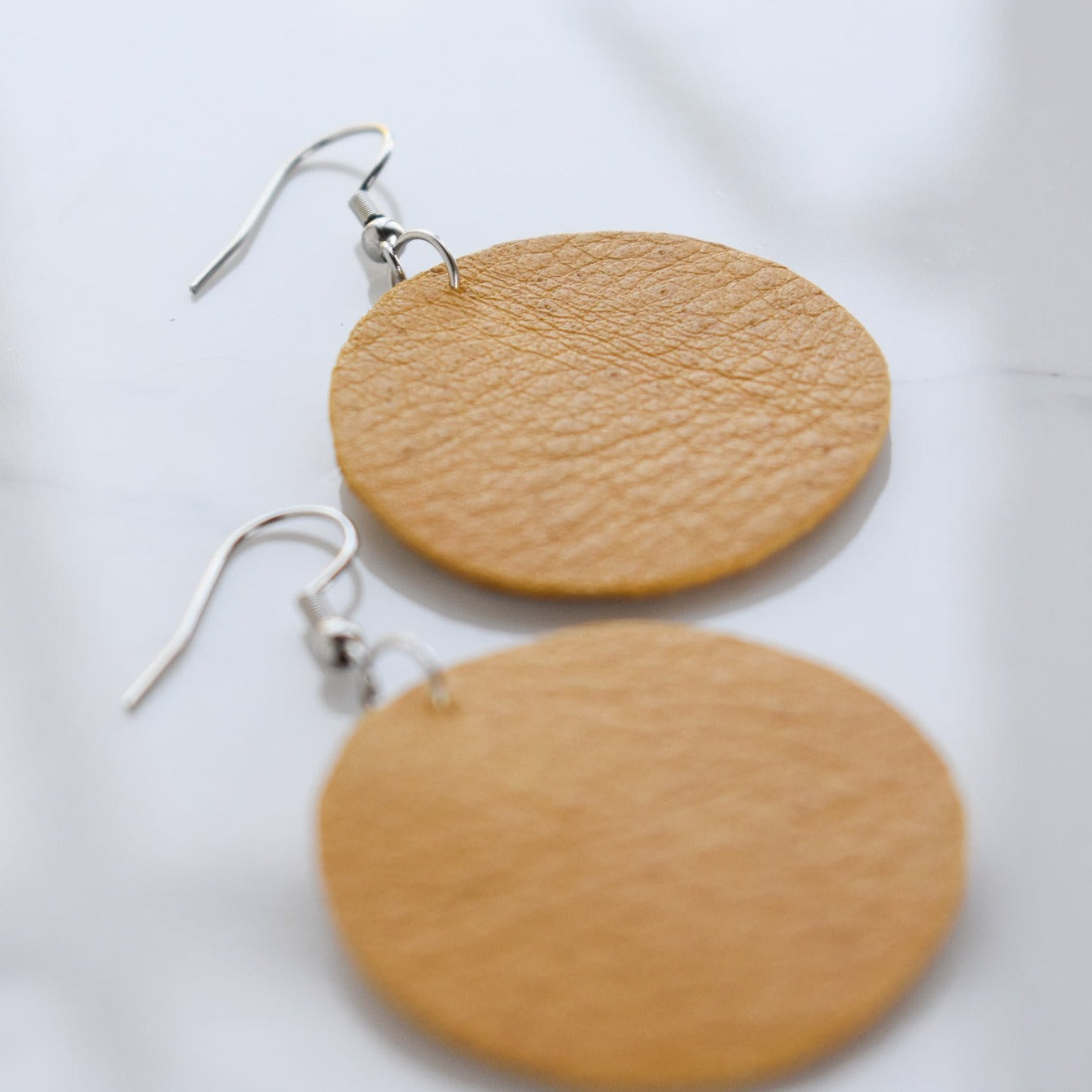 Handmade, light weight and comfortable to wear all day long leather earrings. Available in silver gold or rose gold. All our earring hooks are made with a high quality stainless steel and they are hypo allergenic. They will not tarnish or irritate your sensitive skin.