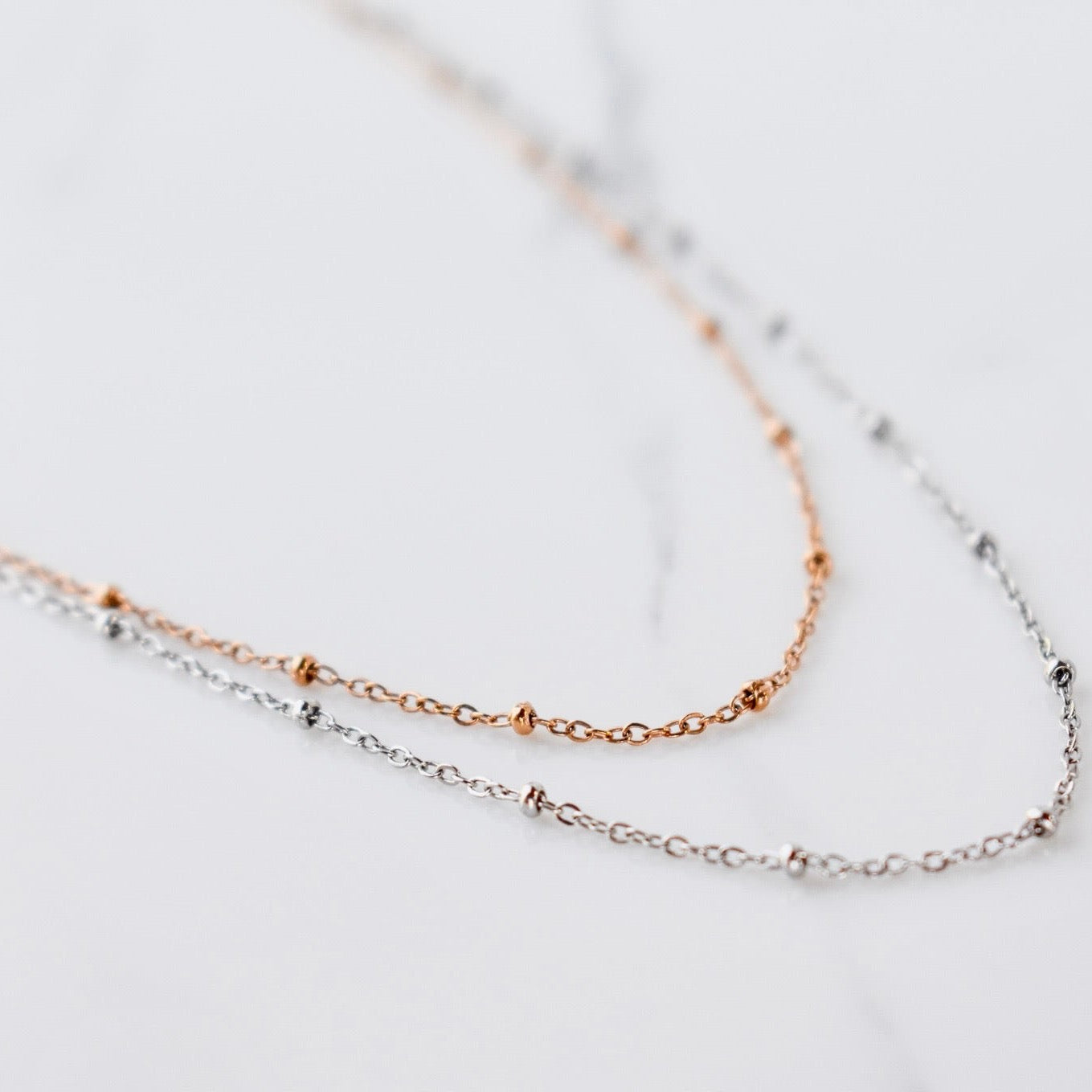 Beautifully handcrafted rose gold and silver ball stainless steel necklace. Waterproof and hypoallergenic.