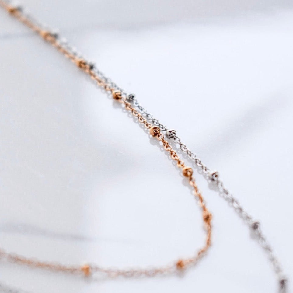 Beautifully handcrafted rose gold and silver ball stainless steel necklace. Waterproof and hypoallergenic.