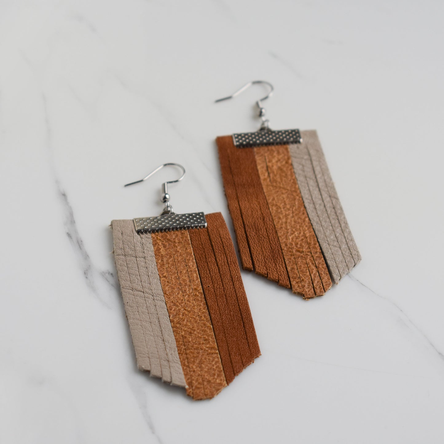 Handmade, light weight and comfortable to wear all day long leather earrings. All our earring hooks are made with a high quality stainless steel and they are hypo allergenic. They will not tarnish or irritate your sensitive skin.