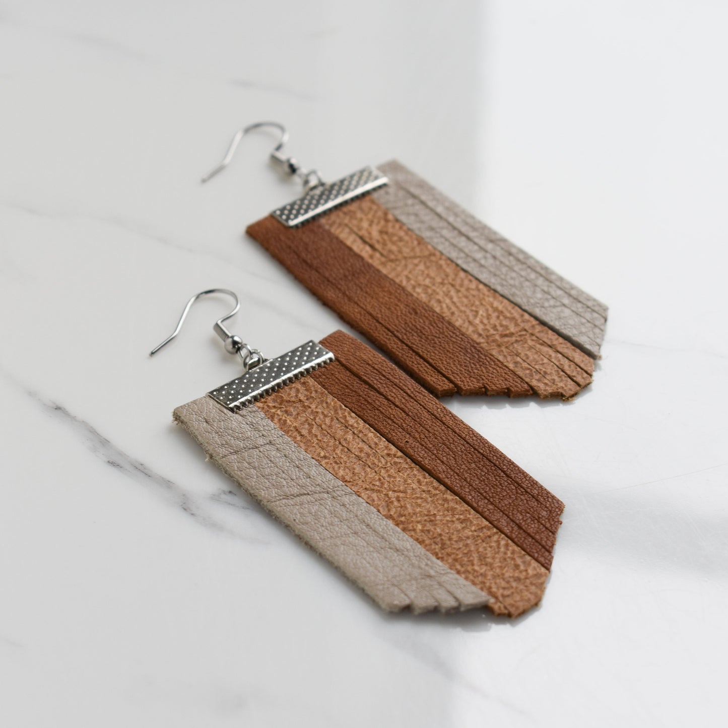 Handmade, light weight and comfortable to wear all day long leather earrings. All our earring hooks are made with a high quality stainless steel and they are hypo allergenic. They will not tarnish or irritate your sensitive skin.