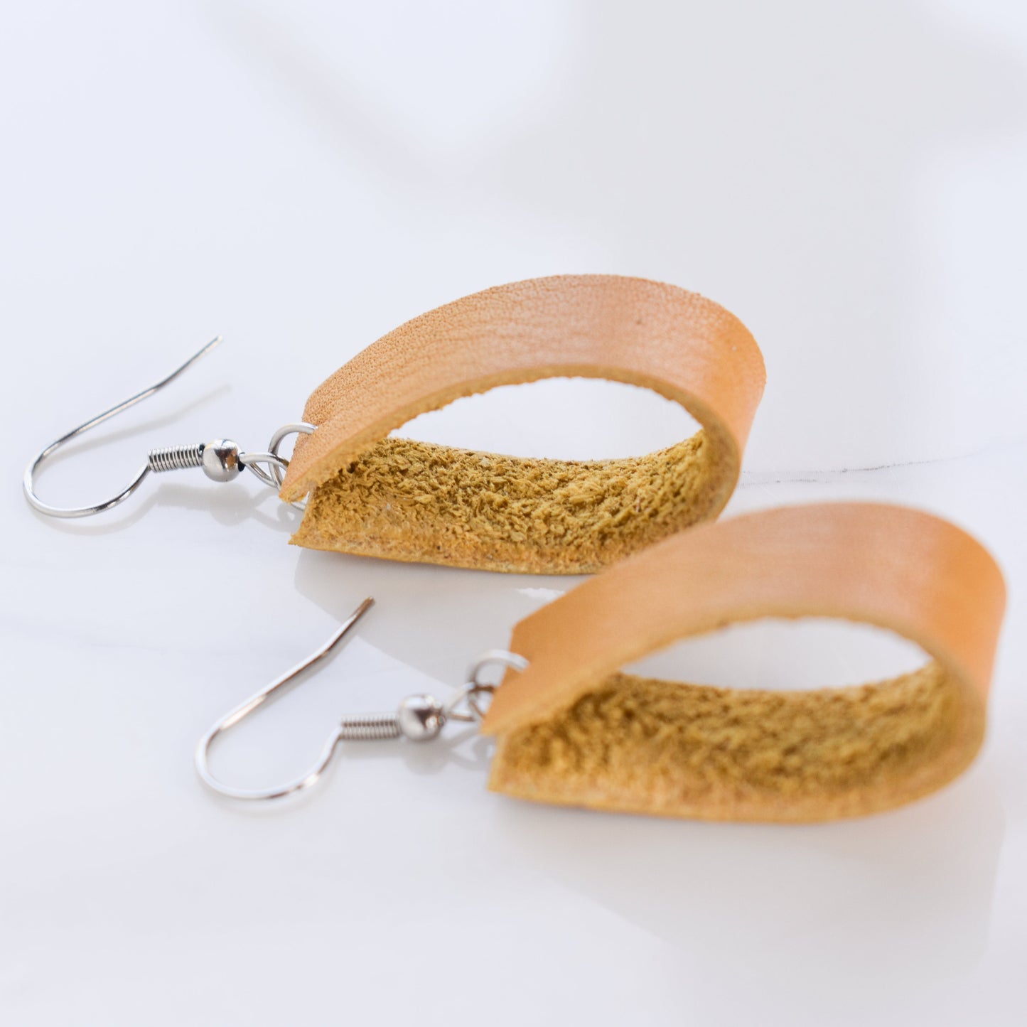 Handmade, light weight and comfortable to wear all day long leather earrings. All our earring hooks are made with a high quality stainless steel and they are hypo allergenic. They will not tarnish or irritate your sensitive skin.