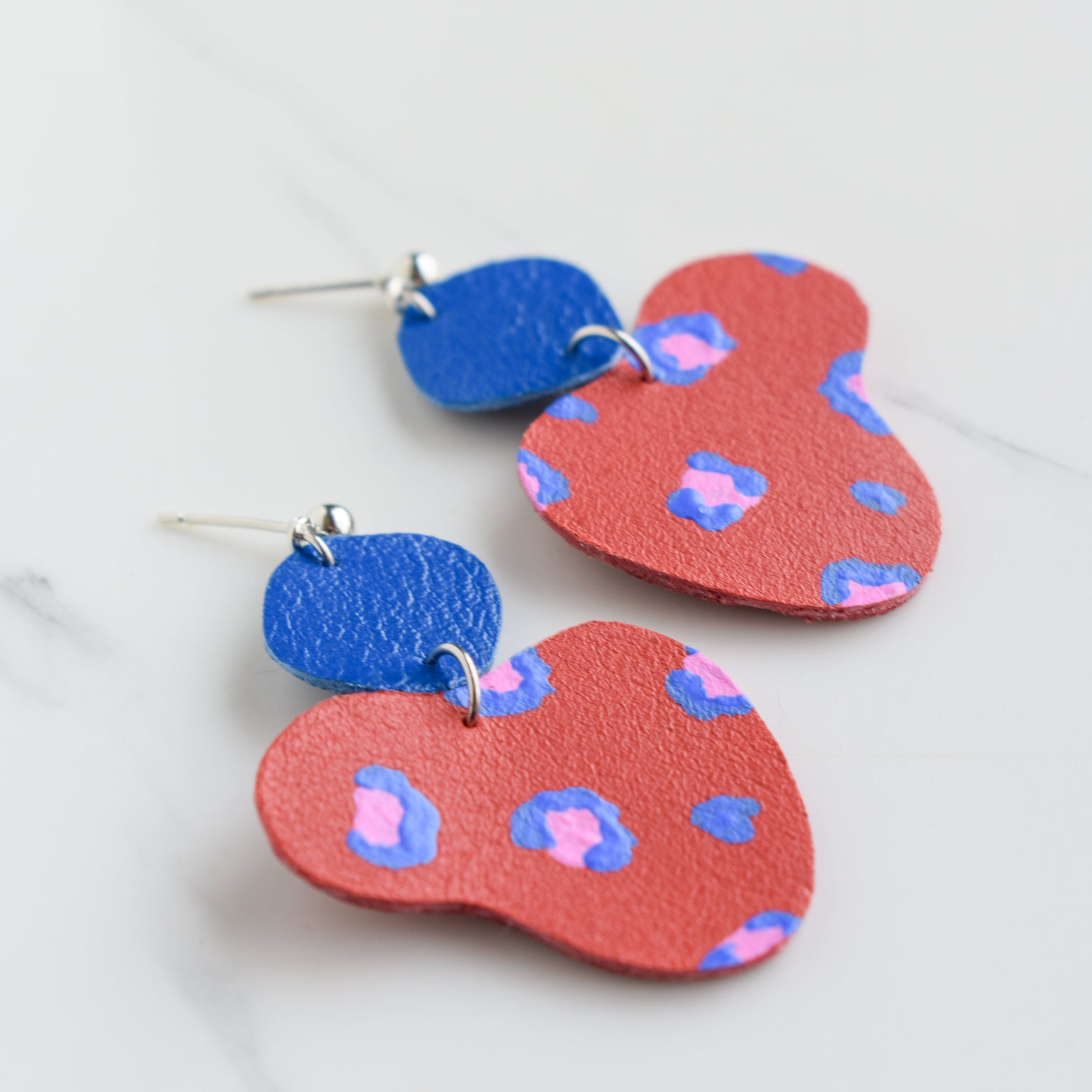 Hand painted and handmade, light weight and comfortable to wear all day long leather earrings. All our earring hooks are made with a high quality stainless steel and they are hypo allergenic. &nbsp;They will not tarnish or irritate your sensitive skin.

