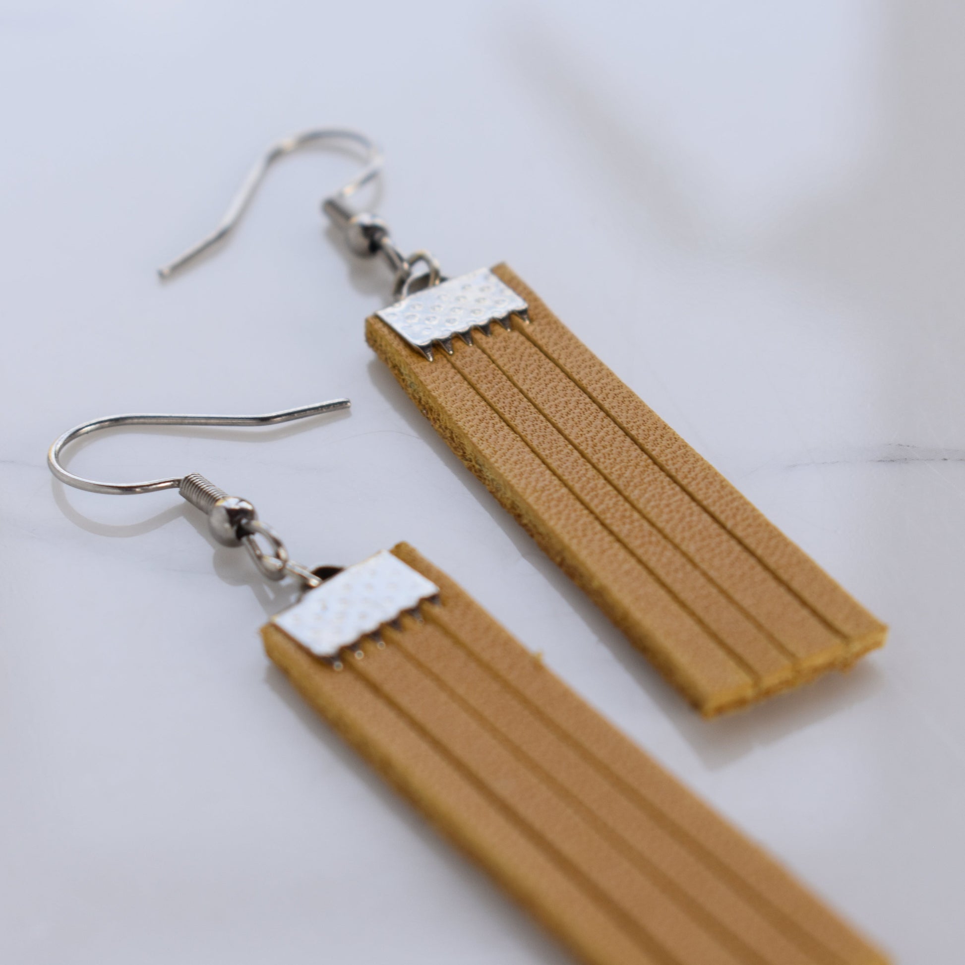 Handmade, light weight and comfortable to wear all day long leather earrings. Available in silver or rose gold. All our earring hooks are made with a high quality stainless steel and they are hypo allergenic.  They will not tarnish or irritate your sensitive skin.