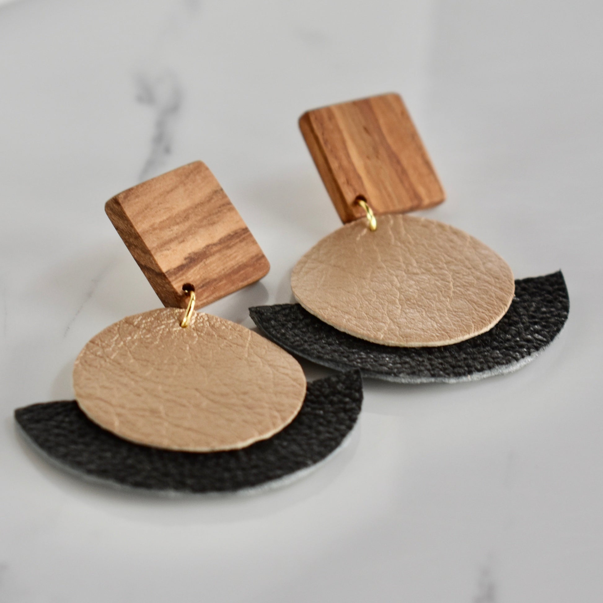 Handmade, light weight and comfortable to wear all day long solid wood (Kiaat) and leather earrings. Available in silver or gold. All our earring hooks are made with a high quality stainless steel and they are hypo allergenic.  They will not tarnish or irritate your sensitive skin.