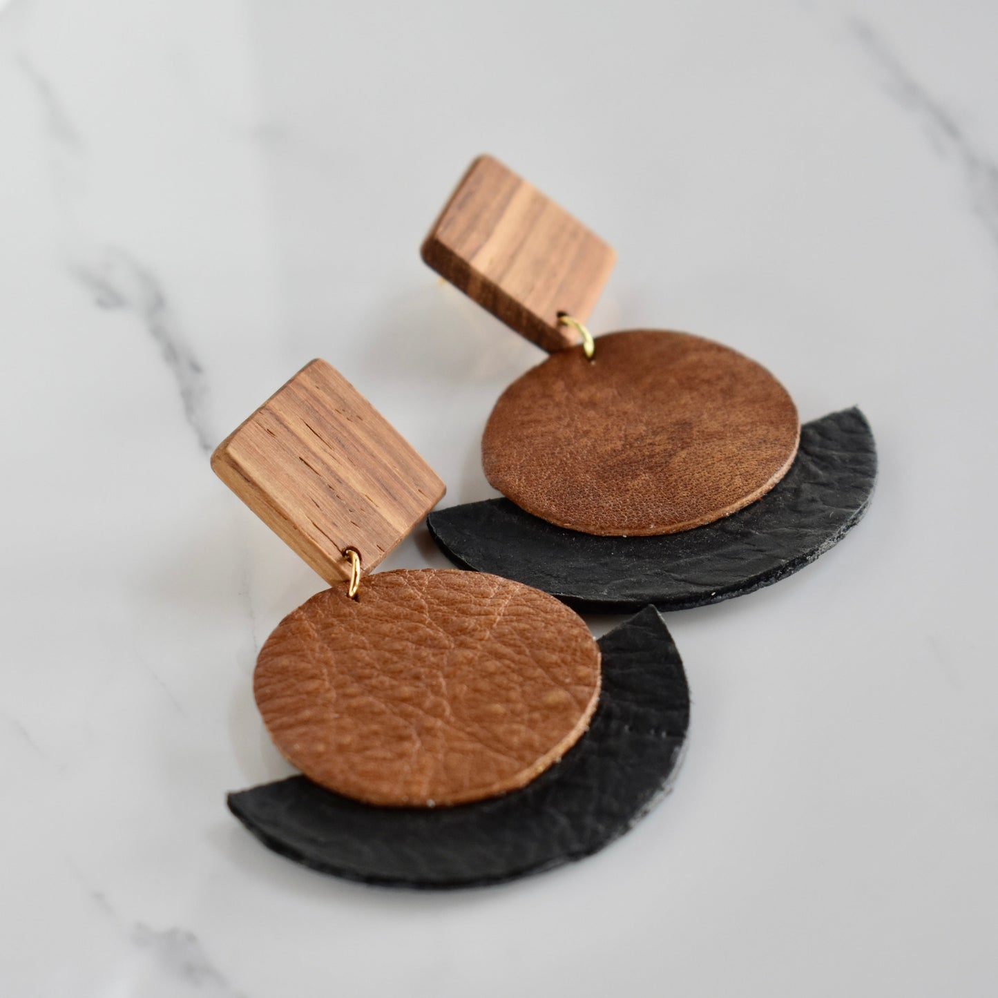 Handmade, light weight and comfortable to wear all day long solid wood (Kiaat) and leather earrings. Available in silver or gold. All our earring hooks are made with a high quality stainless steel and they are hypo allergenic.  They will not tarnish or irritate your sensitive skin.