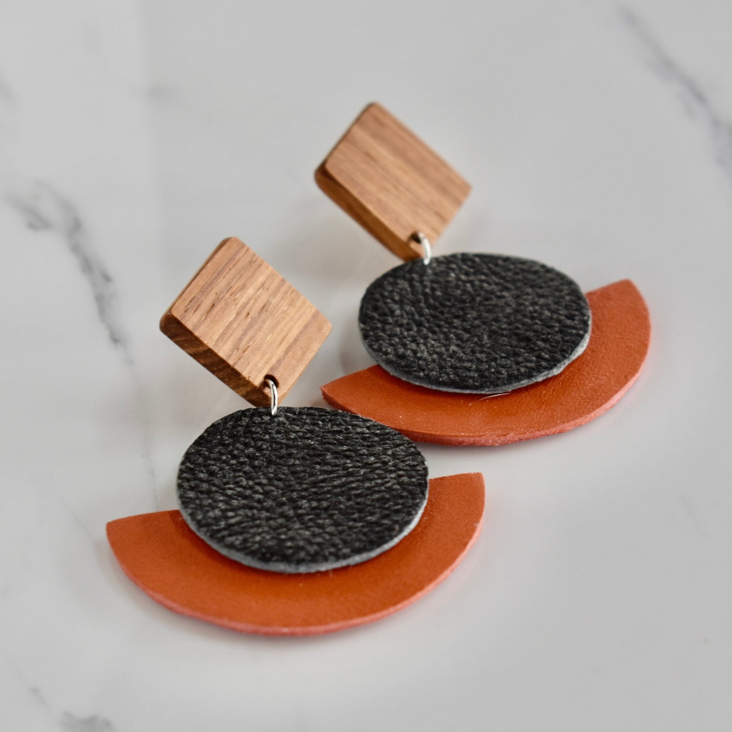 Handmade, light weight and comfortable to wear all day long solid wood (Kiaat) and leather earrings. Available in silver or gold. All our earring hooks are made with a high quality stainless steel and they are hypo allergenic.  They will not tarnish or irritate your sensitive skin.