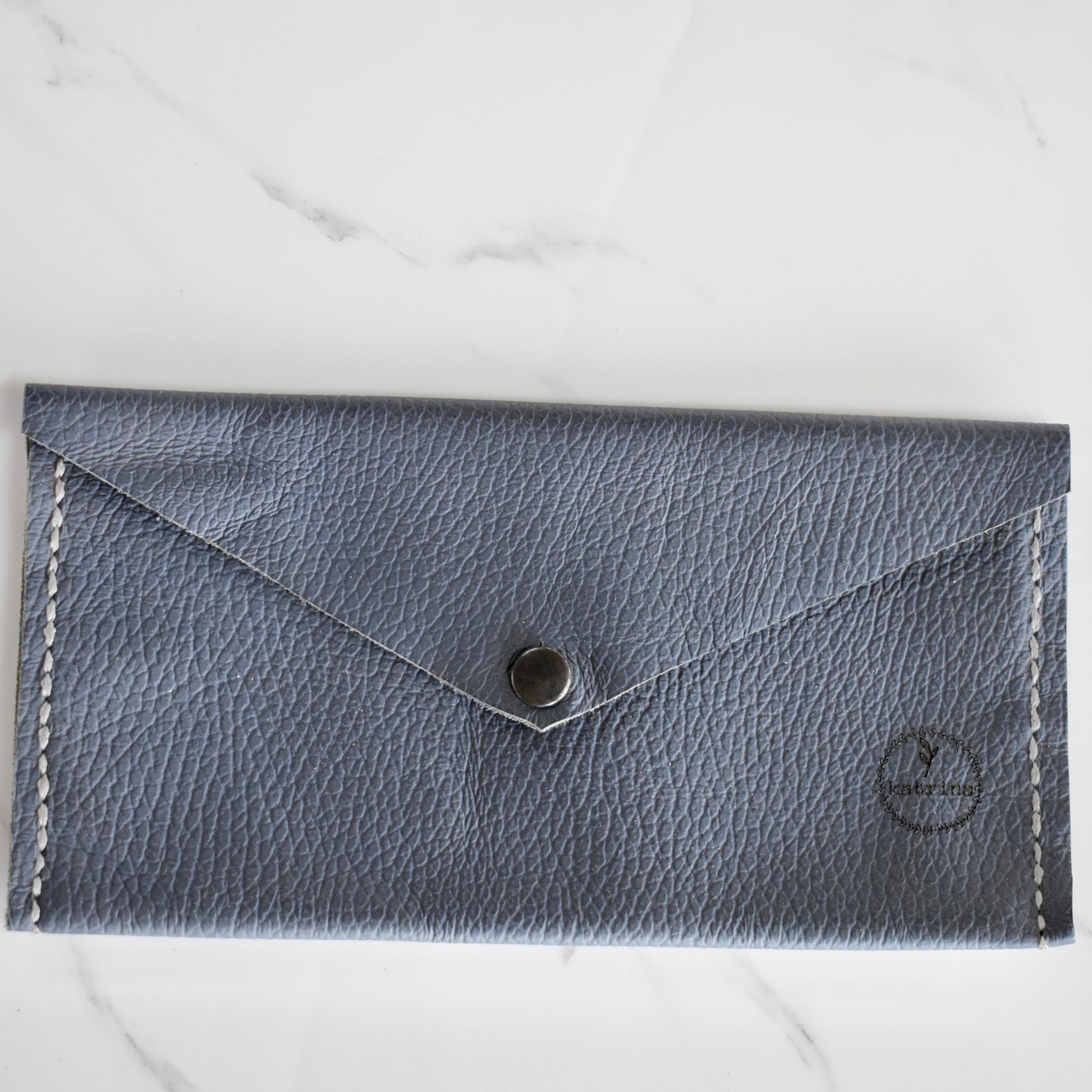 Beautifully handmade and hand stitched leather clutch. Perfect for a quick trip to the shop or even to keep your sunglasses save. Use it as a make up bag or pencil case. This also makes an amazing addition to a bridesmaids gift box. 