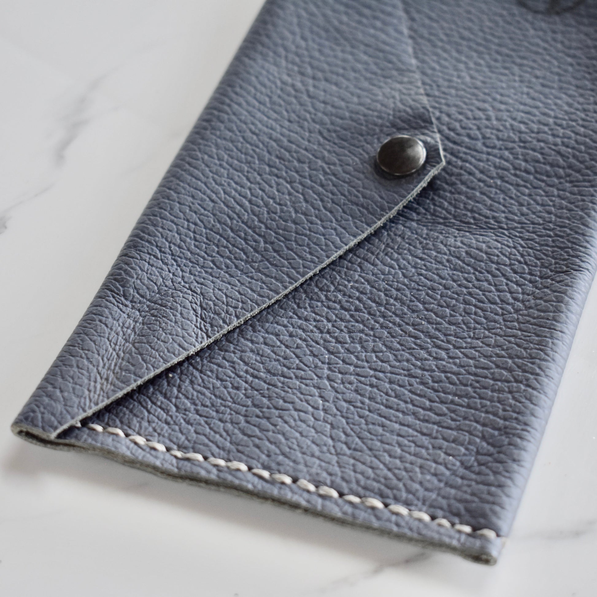 Beautifully handmade and hand stitched leather clutch. Perfect for a quick trip to the shop or even to keep your sunglasses save. Use it as a make up bag or pencil case. This also makes an amazing addition to a bridesmaids gift box. 