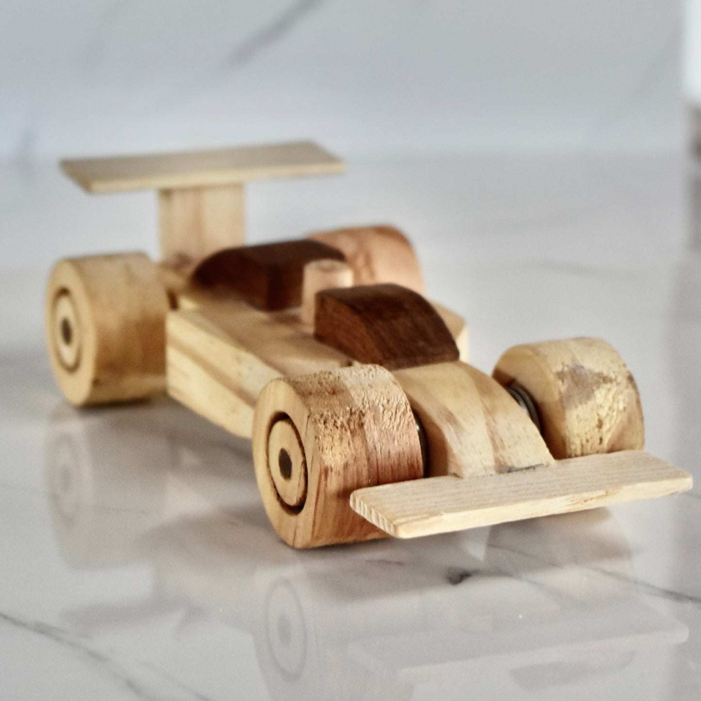 This small handmade wooden F1 racing car is the perfect present for any kid (or kid at heart)! It can be left as is or painted for an extra touch of fun. Makes for an amazing baby shower gift. Made with Kiaat solid wood and pine. 