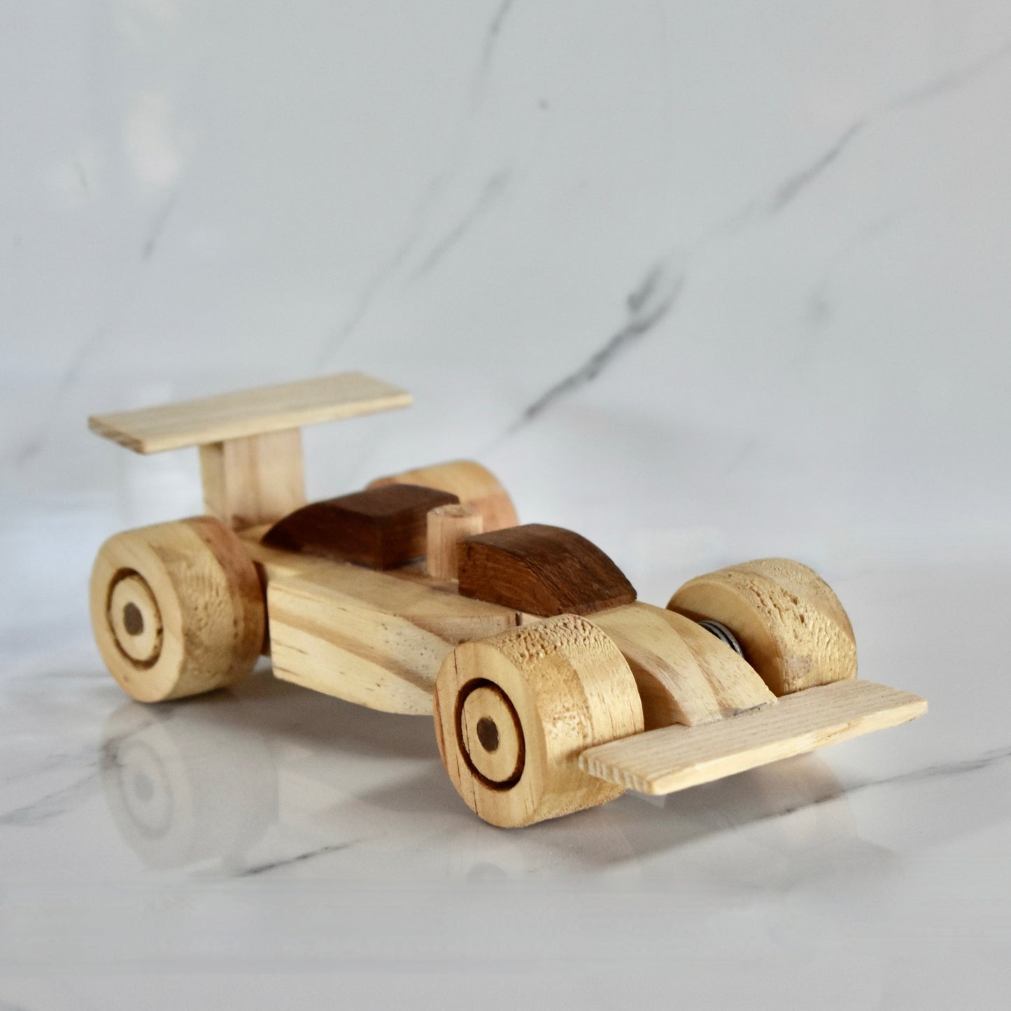 This small handmade wooden F1 racing car is the perfect present for any kid (or kid at heart)! It can be left as is or painted for an extra touch of fun. Makes for an amazing baby shower gift. Made with Kiaat solid wood and pine. 