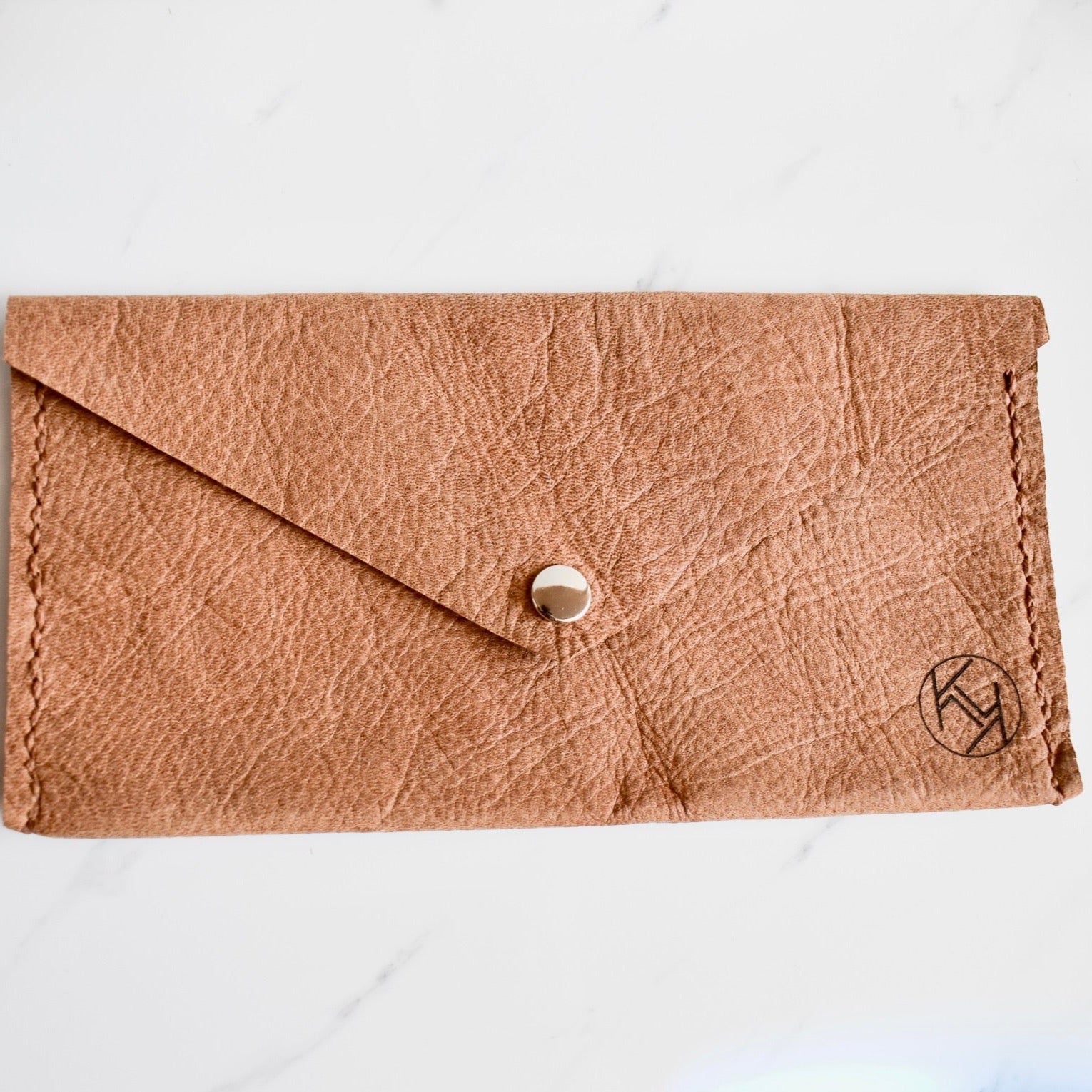 Beautifully handmade and hand stitched leather clutch. Perfect for a quick trip to the shop or even to keep your sunglasses save. Use it as a make up bag or pencil case. This also makes an amazing addition to a bridesmaids gift box. 