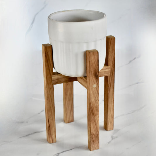 This exquisite wooden plant stand, handcrafted with solid Kiaat wood, is the perfect addition to any plant lover's collection. With its elegant and sophisticated design, it will elevate any space it graces. Stand only.