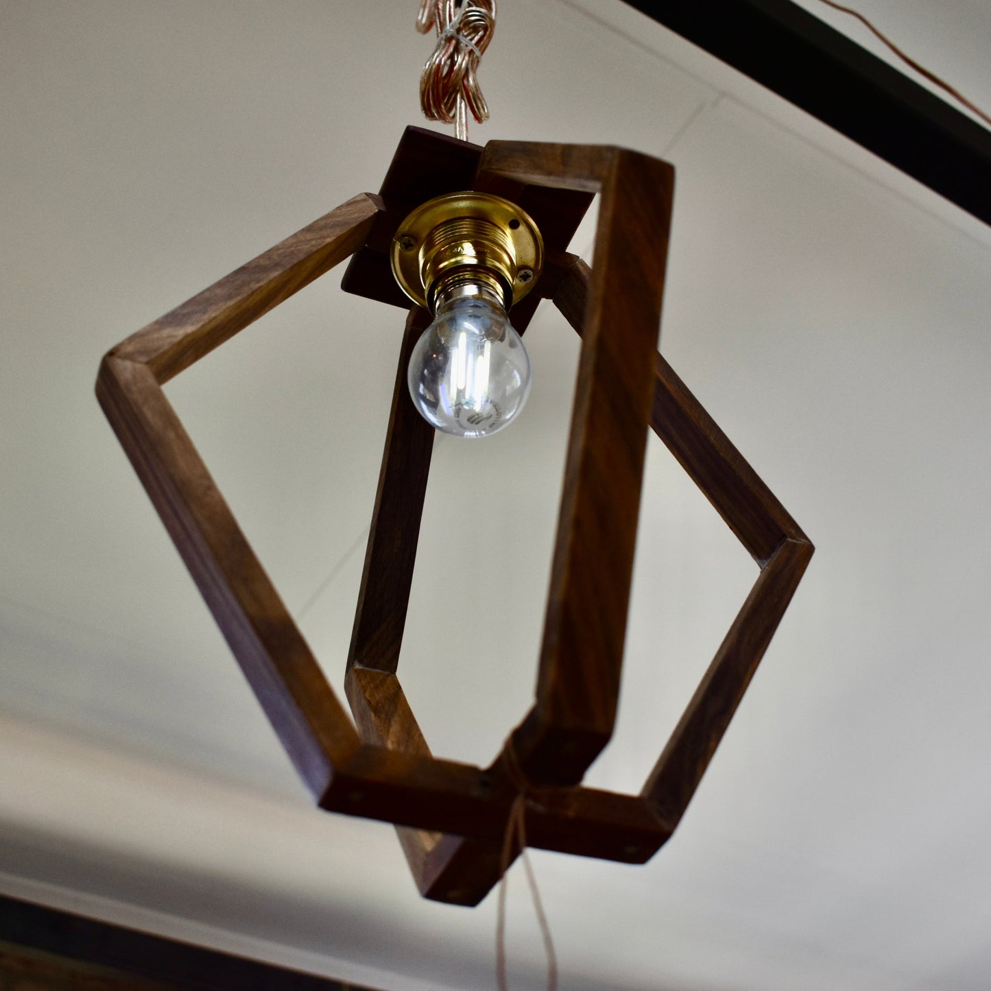 Crafted from durable Kiaat wood, this exquisite modern pendant will add a touch of sophistication to any room.