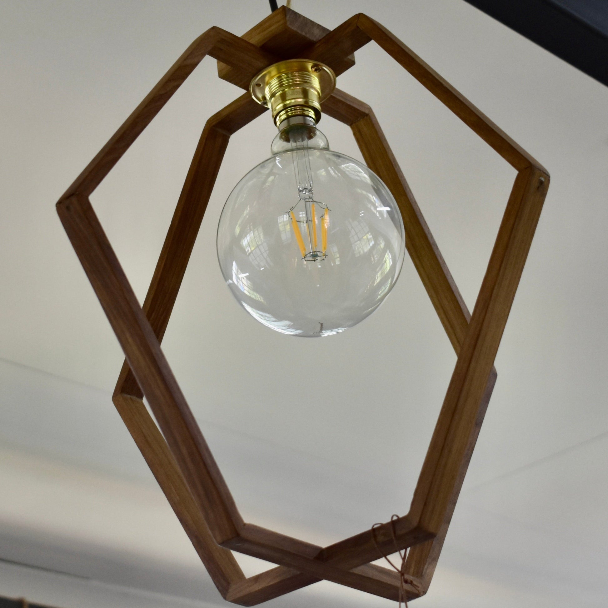 Crafted from durable Kiaat wood, this exquisite modern pendant will add a touch of sophistication to any room.