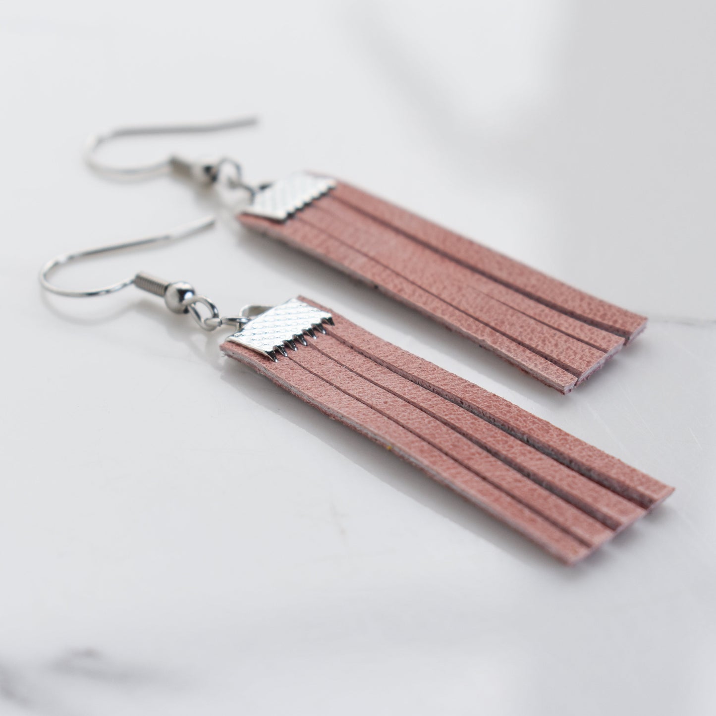 Handmade, light weight and comfortable to wear all day long leather earrings. Available in silver or rose gold. All our earring hooks are made with a high quality stainless steel and they are hypo allergenic.  They will not tarnish or irritate your sensitive skin.