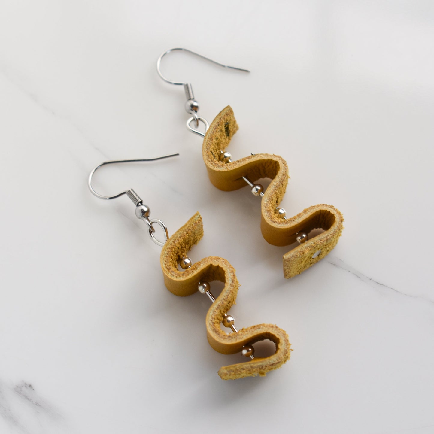 Handmade, light weight and comfortable to wear all day long leather earrings. All our earring hooks are made with a high quality stainless steel and they are hypo allergenic.  They will not tarnish or irritate your sensitive skin.